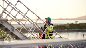 Employee walking up stairs at processing plant