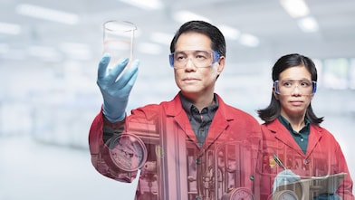 Two scientist in a red lab coat