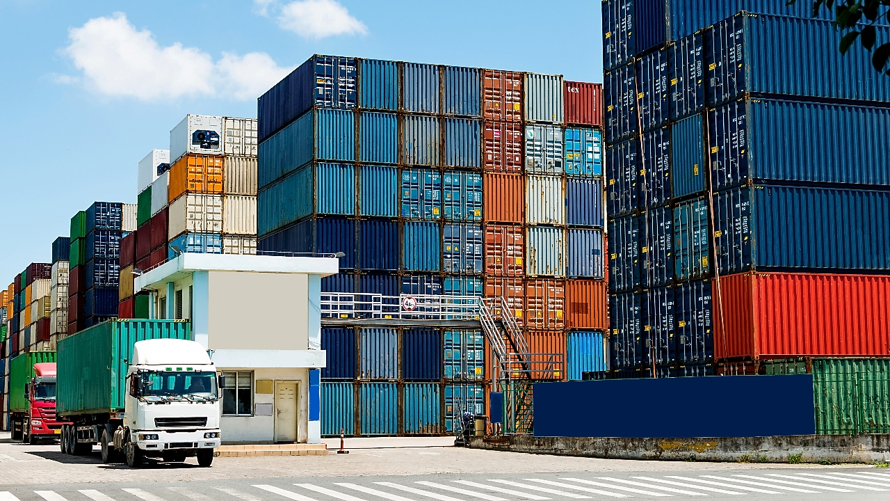 A stack of containers with a truck passing by