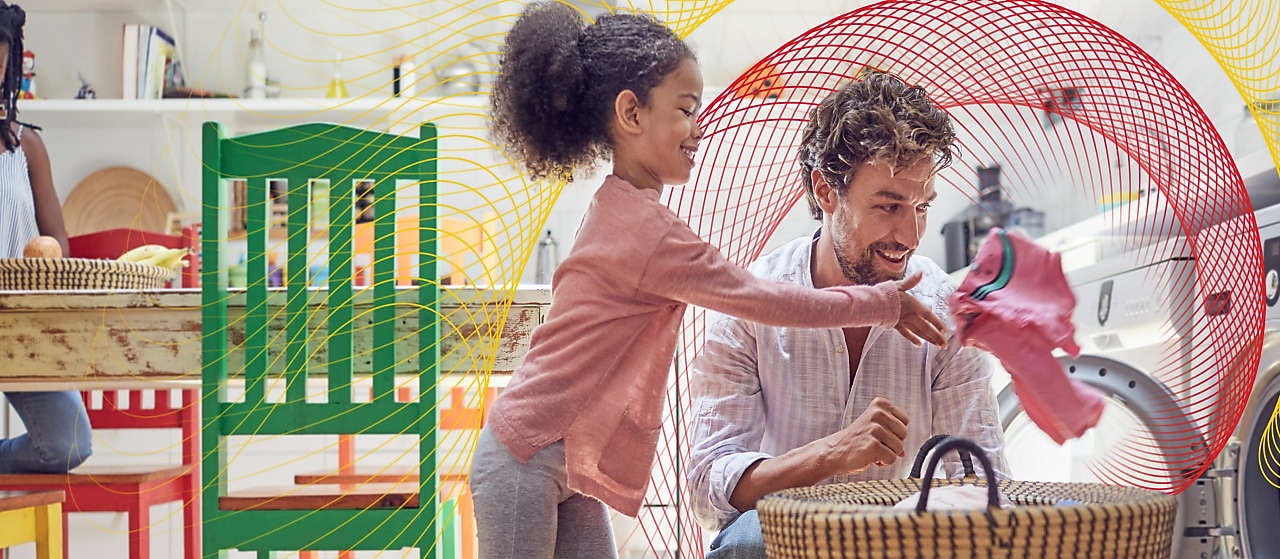 A dad and his daughter are doing laundry together