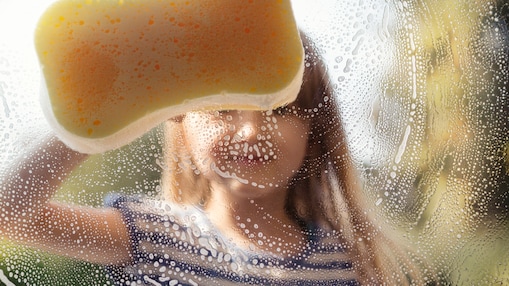 a girl cleaning window