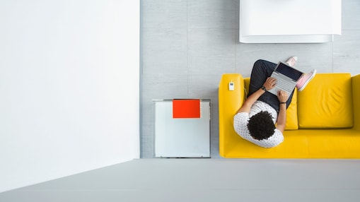 Person relaxing on a sofa in the office