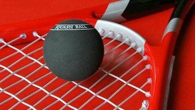 Squash ball on a racket