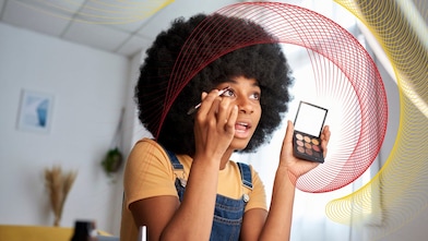 a lady putting makeup on