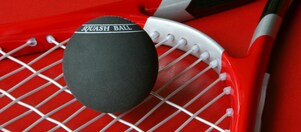Chemicals phenol close up of a squash ball sitting on a racket