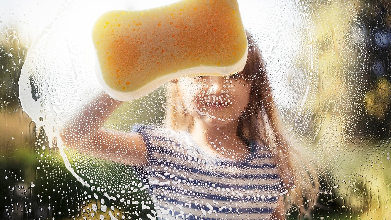 A girl cleaning the glass