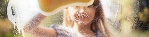 A girl cleaning the glass