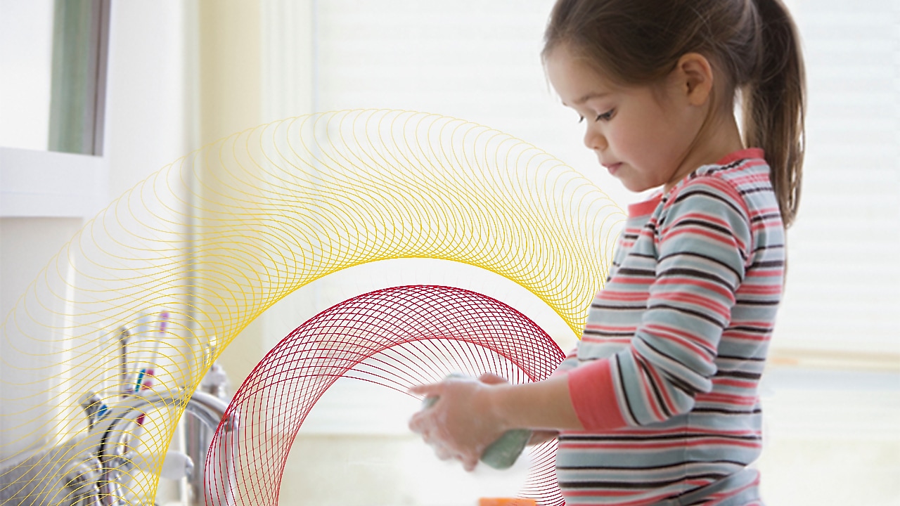 A baby washing her hands