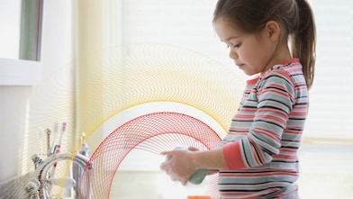 A baby washing her hands