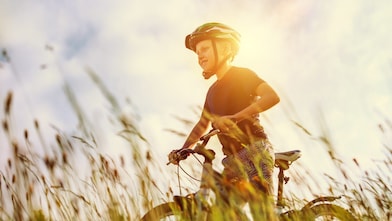 Young boy doing up a cycling helmet