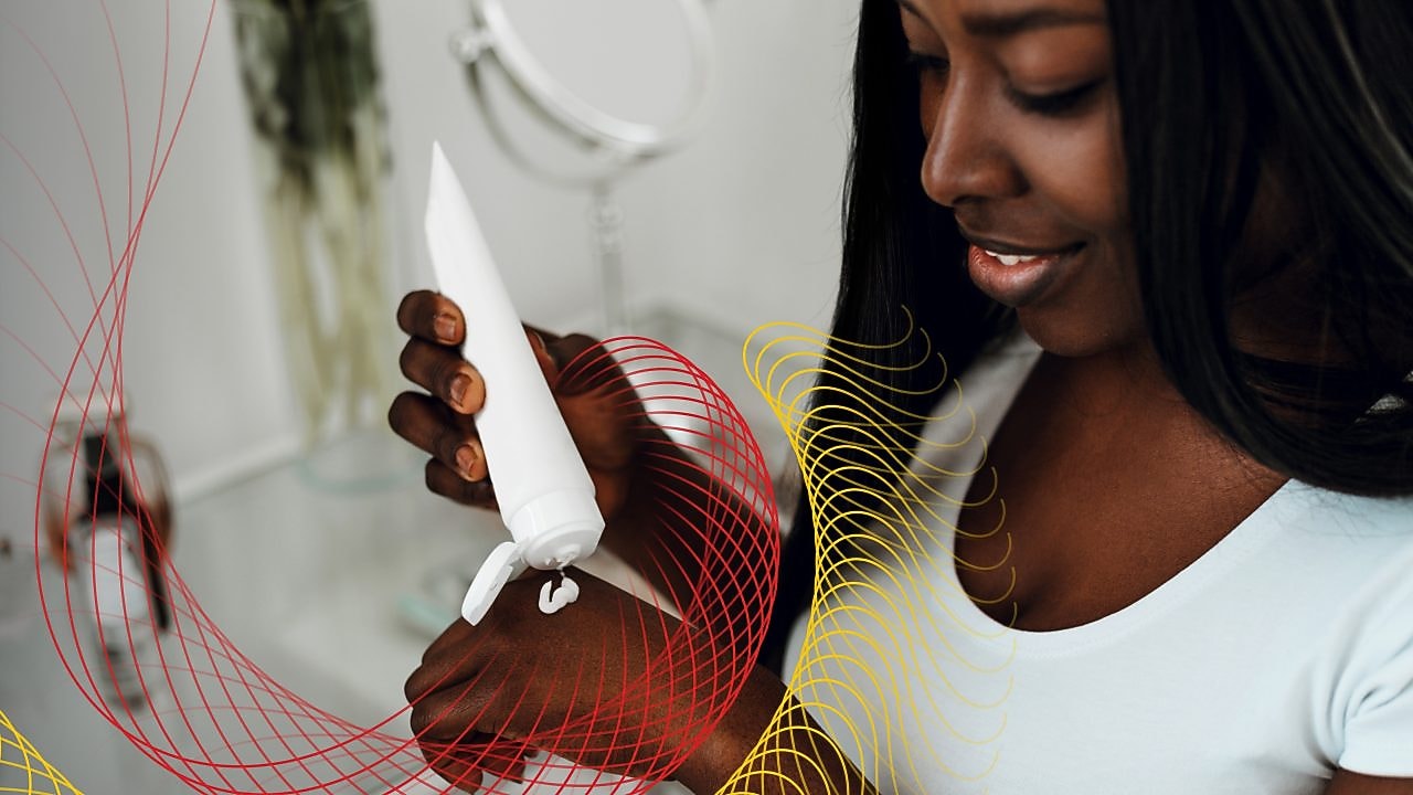 Woman applying lotion on hand