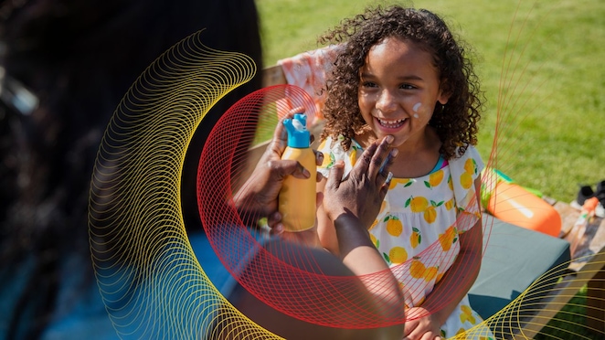 Mother applying sunscreen to child