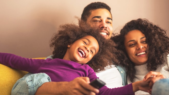 Smiling family sitting on couch