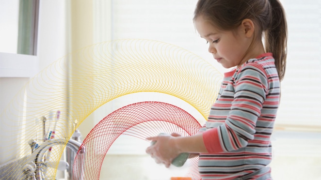 A baby washing her hands