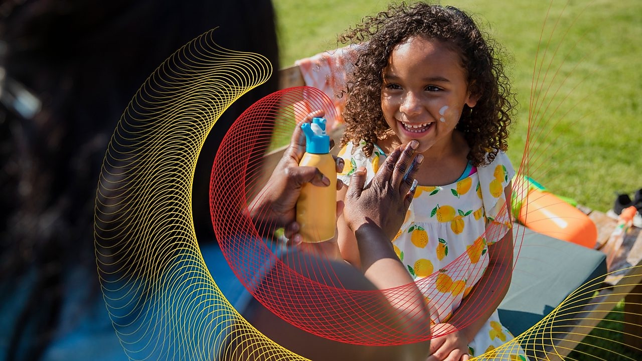 Mom putting sunblock on daughter face