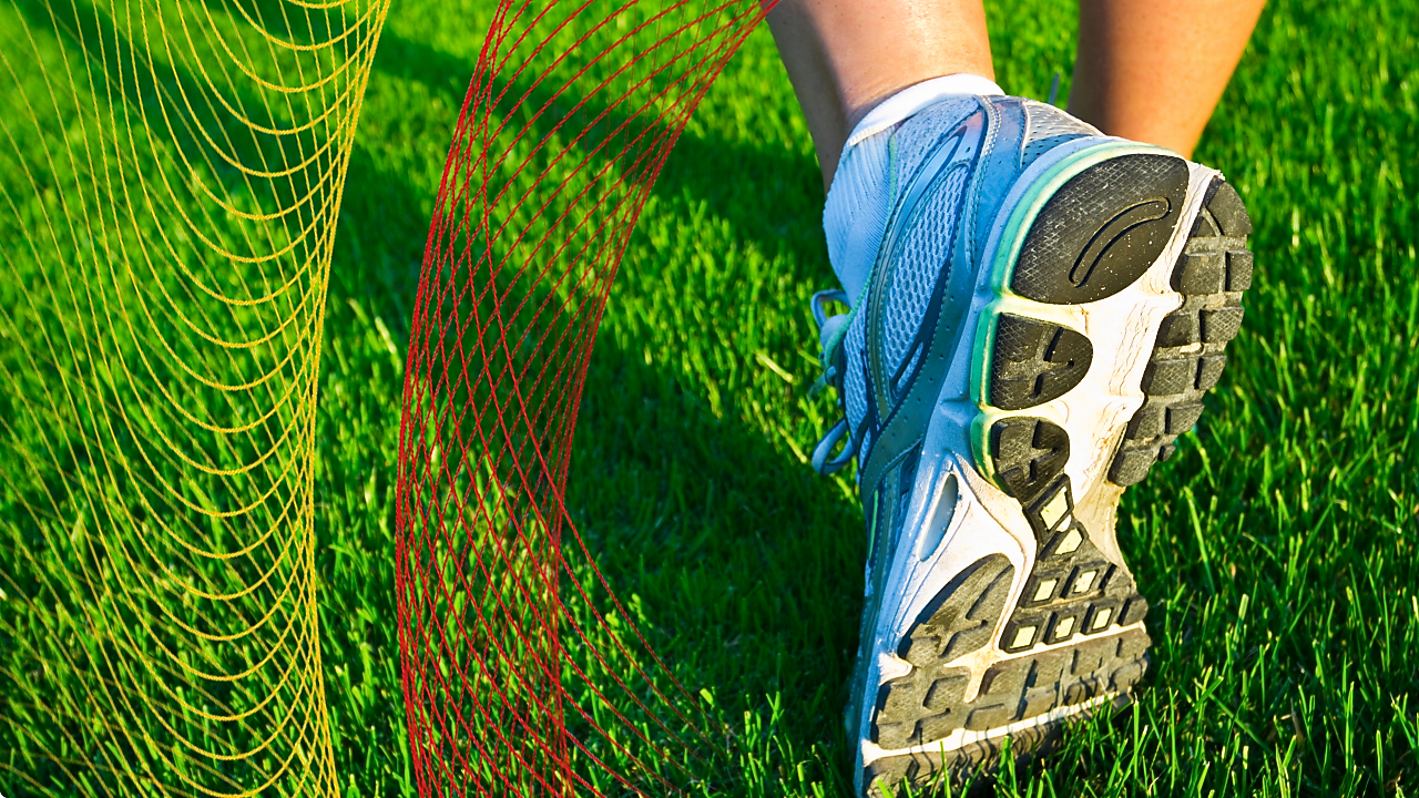 Running shoe on green grass