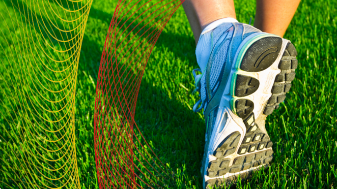 Running shoe on green grass