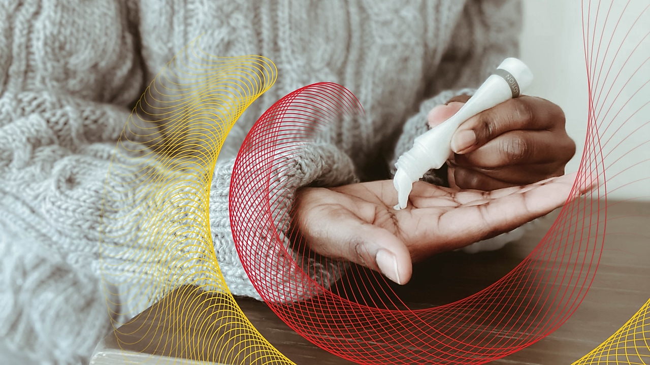 Woman applies lotion to hands