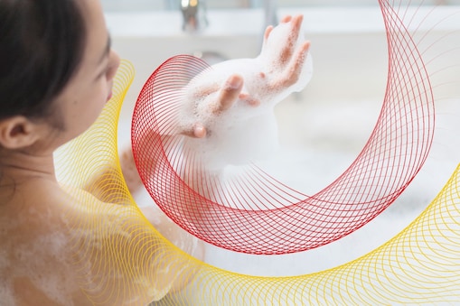 a woman in the tub with the suds