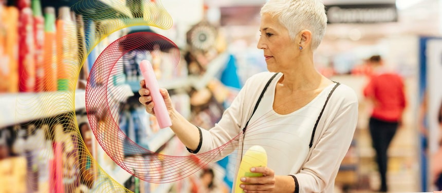 a lady with the short white hair holding the two PC bottles