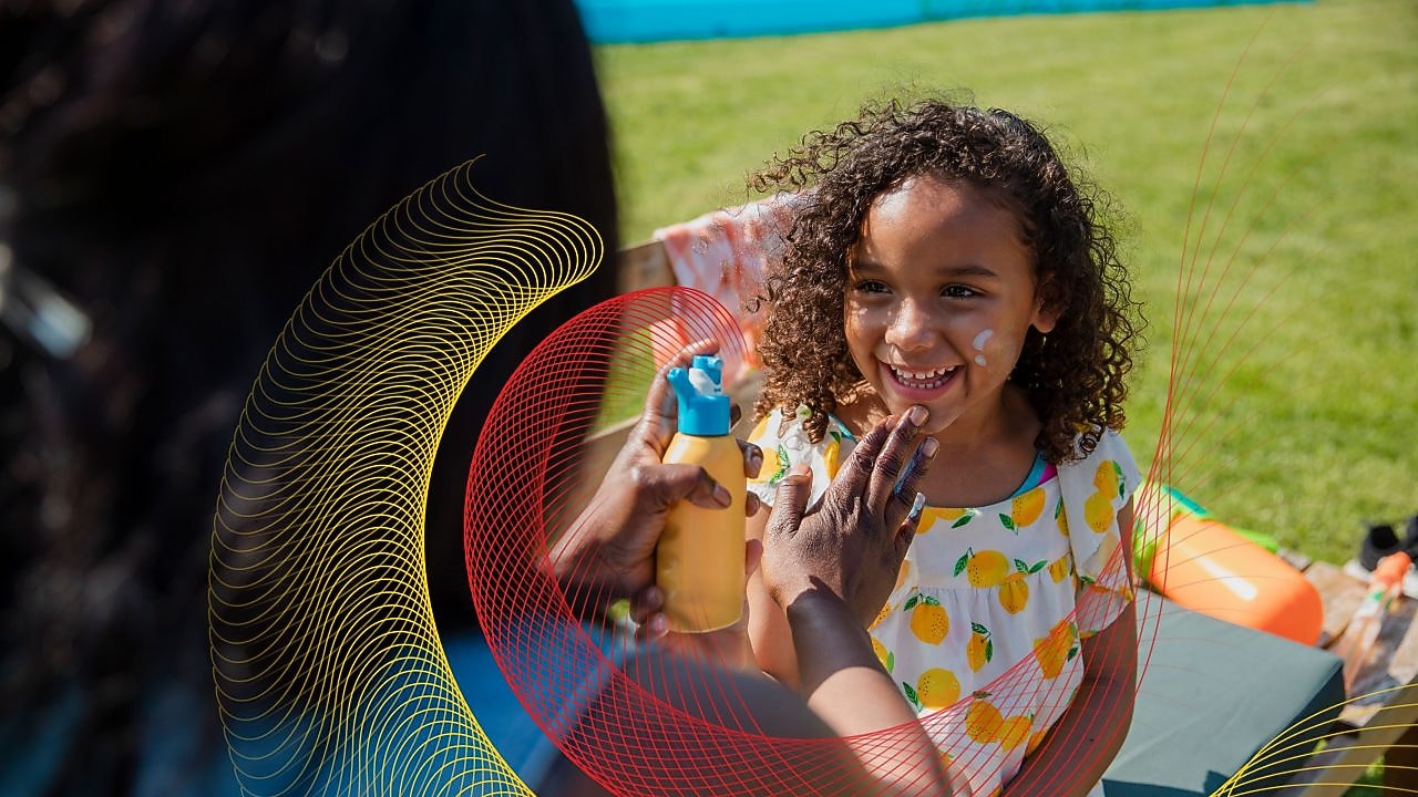 Mom putting sunblock son daughter’s face