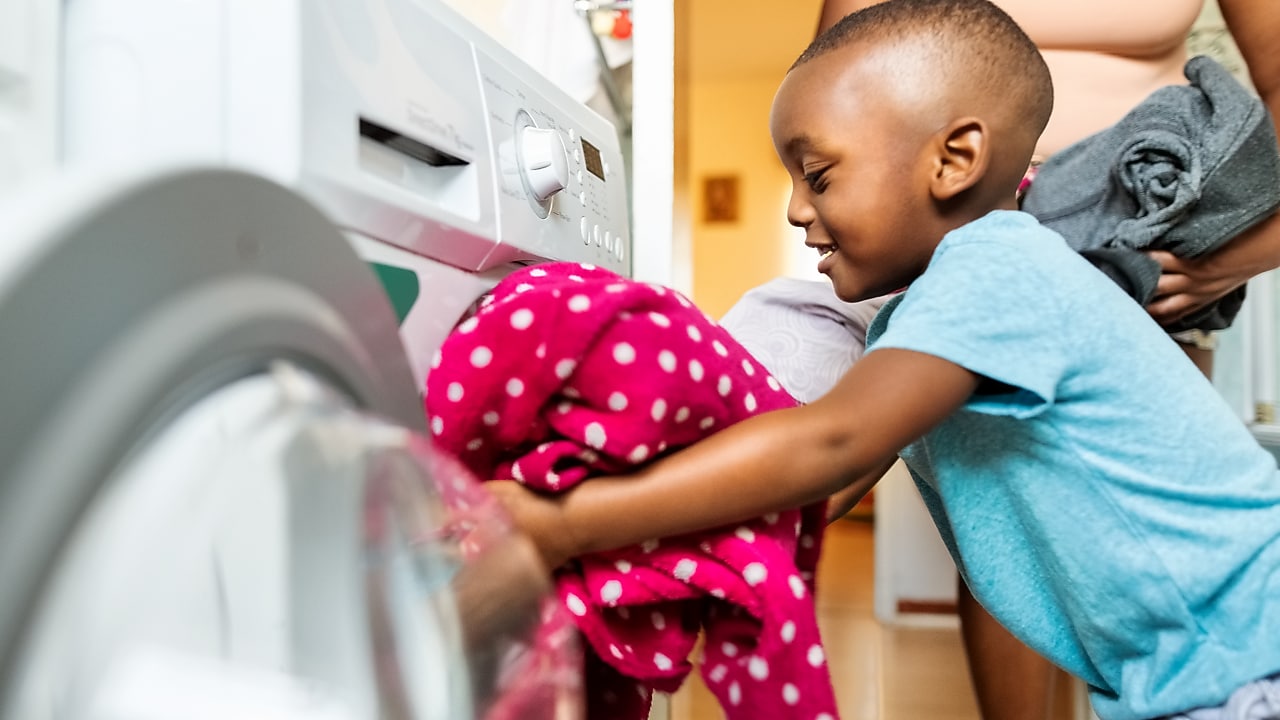 Child using washing machine