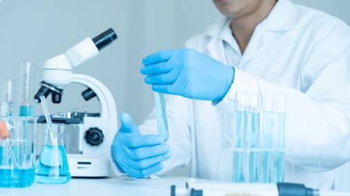 person holding vile in lab