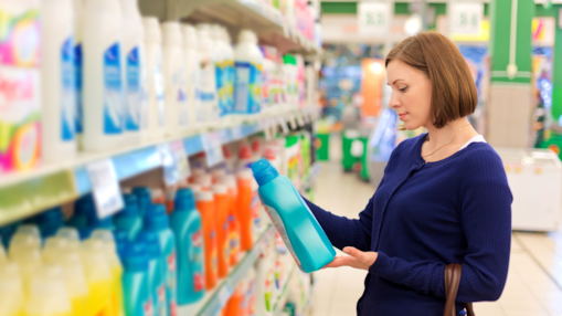 woman looking at laundry detergent in store