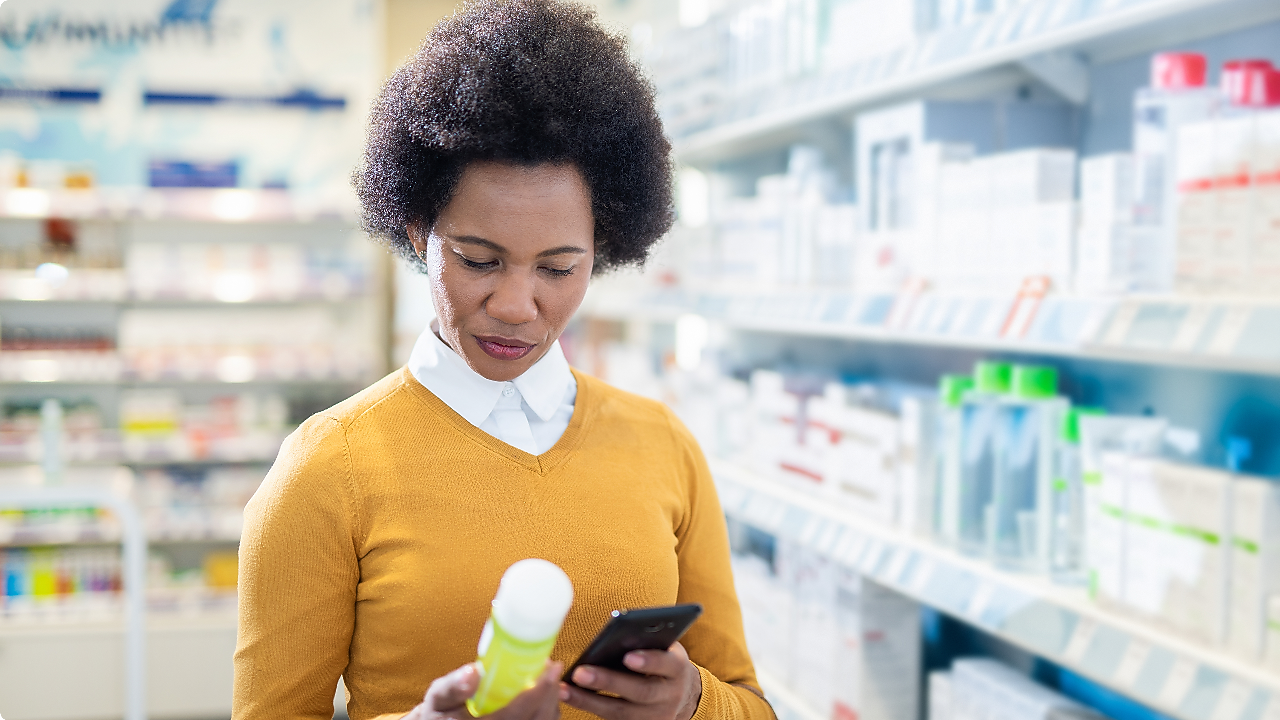 Consumer holding and examining a personal care product in a retail store