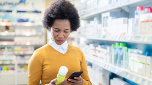 Consumer holding and examining a personal care product in a retail store