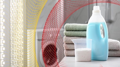 detergent bottle with folded towels in background