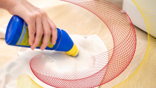 hand holding stain remover bottle