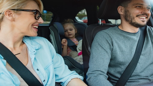 Family smiling in car