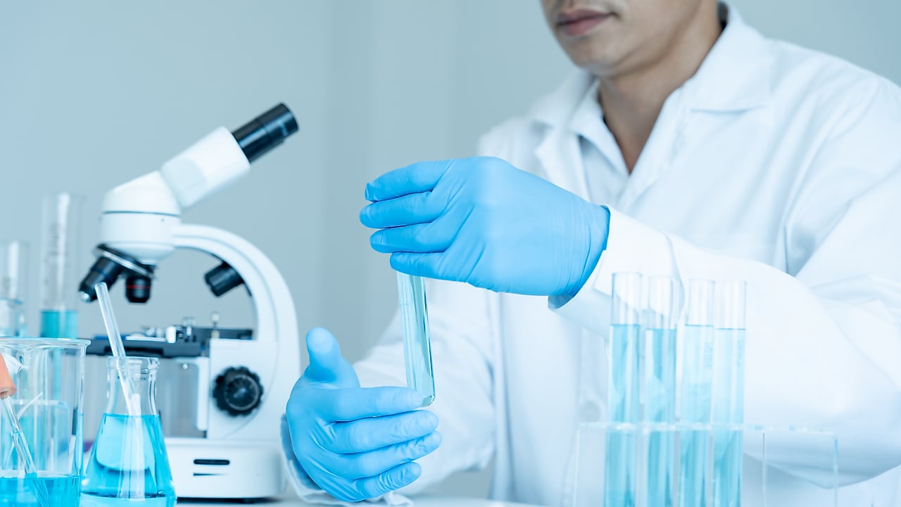 Scientist in lab measuring ingredients