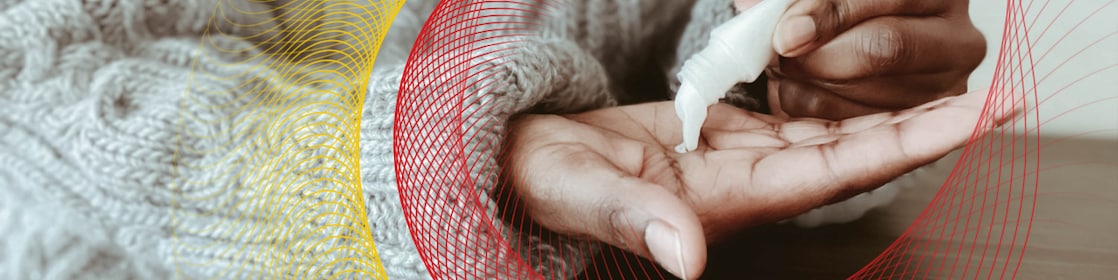 Closeup of person squeezing lotion from tube into palm of hand