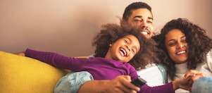Smiling family sitting on couch