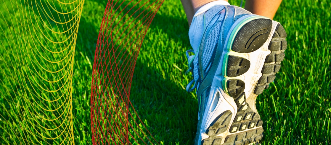 Running shoe on green grass
