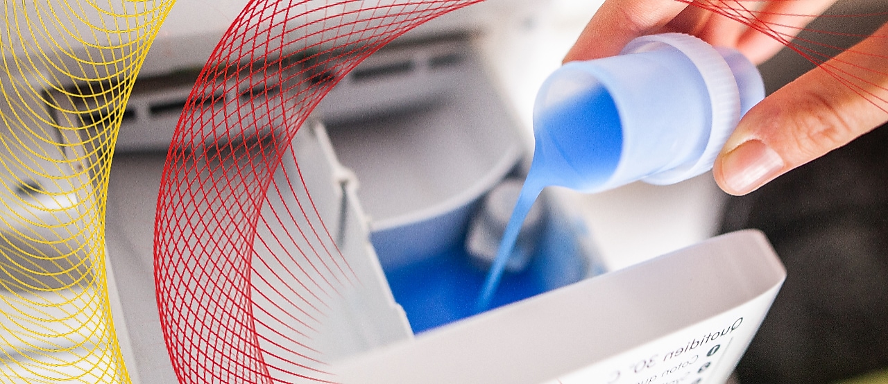 Laundry detergent being poured into washing machine