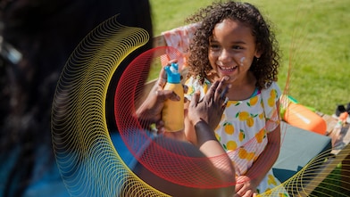 Mom putting sunblock on daughter’s face