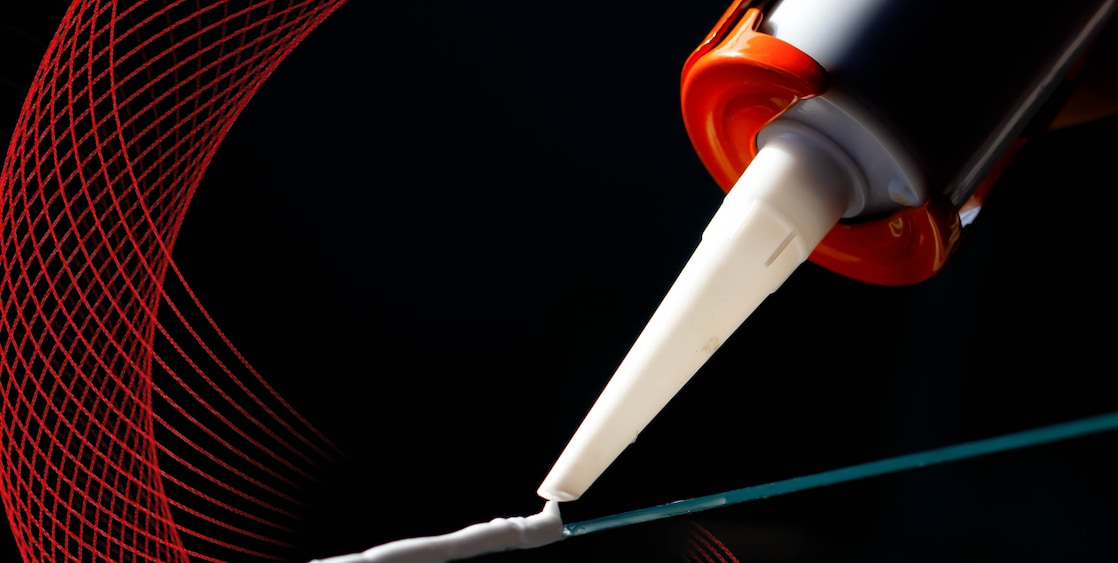 caulking gun applying adhesive to a surface