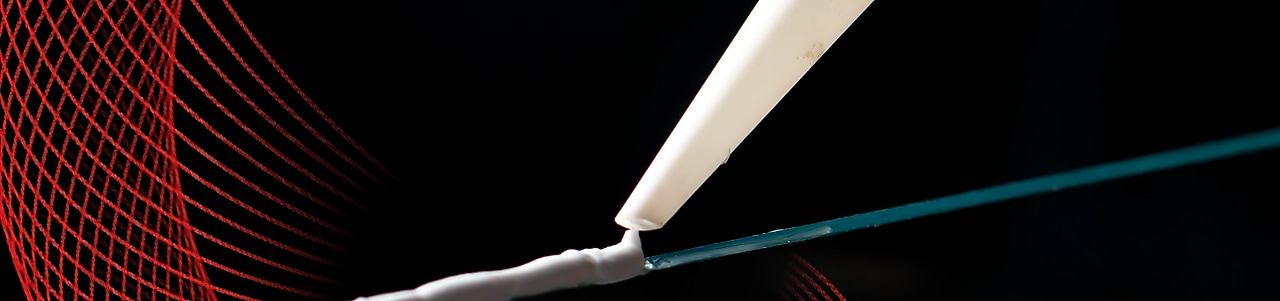 caulking gun applying adhesive to a surface