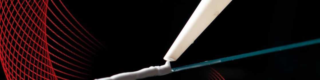 caulking gun applying adhesive to a surface