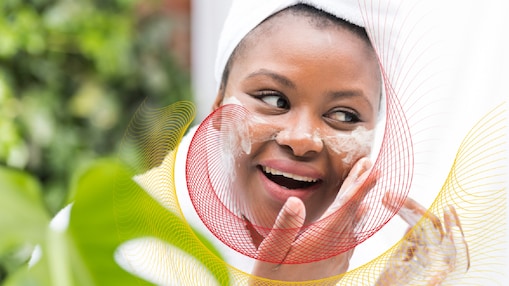 Woman washing her face outdoors in a robe