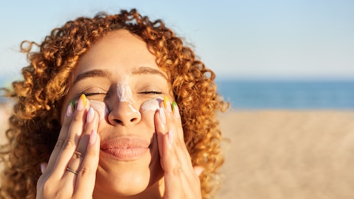 woman applying sunscreen to face