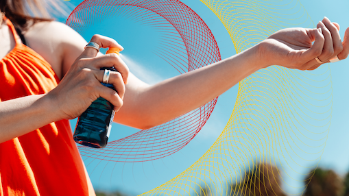 person spraying sunscreen on arm