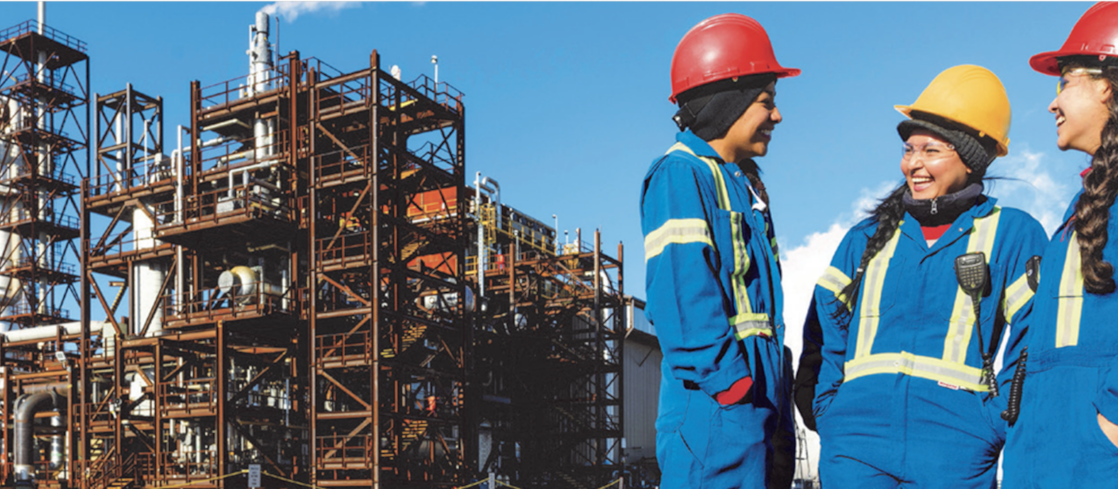 Industrial facility with workers in protective gear