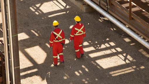 Workers walking through industrial facility