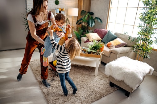 A mom and her children playing in a living room