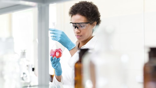 Woman scientist studying conical flask