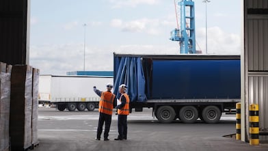 A man pointing to a truck trailer